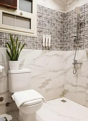 a white bathroom with a toilet and a shower at Hurghada stylish Apartment on the beach in Hurghada