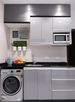a kitchen with white cabinets and a washing machine at Hurghada stylish Apartment on the beach in Hurghada