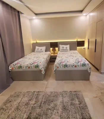 a bedroom with two beds and a rug at Mirage bay aquapark 772B in Hurghada