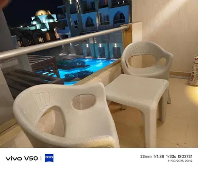 a room with a chair and a table on a balcony at Sahl hashish in Hurghada