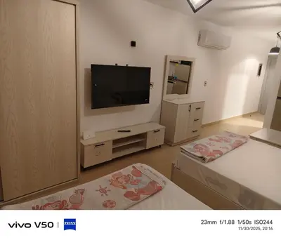 a living room with a flat screen tv on the wall at Sahl hashish in Hurghada