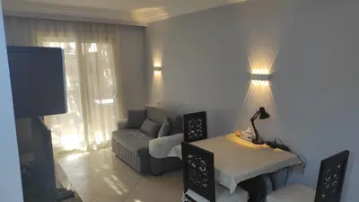 a living room with a couch and a tv at Apartment with garden in sahl hasheesh in Hurghada