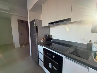 a kitchen with a stove and a counter top at Fresh & Modern 2BR • Newly Furnished Kamaran in Hurghada