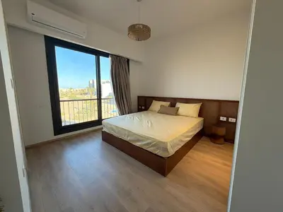 a bedroom with a bed and a large window at Fresh & Modern 2BR • Newly Furnished Kamaran in Hurghada