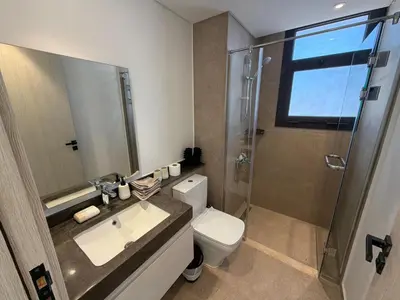 a bathroom with a toilet and a sink and a shower at Fresh & Modern 2BR • Newly Furnished Kamaran in Hurghada