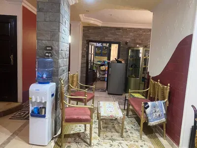 a room with chairs and a heater in a room at فيلا المدينة البعيدة in Naj‘ al Maḩaţţah