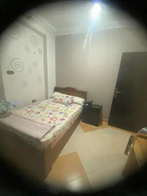 a small bedroom with a bed in a room at فيلا المدينة البعيدة in Naj‘ al Maḩaţţah