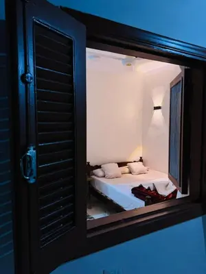 a view of a bedroom with a bed through a window at MERIT Guest House in Aswan