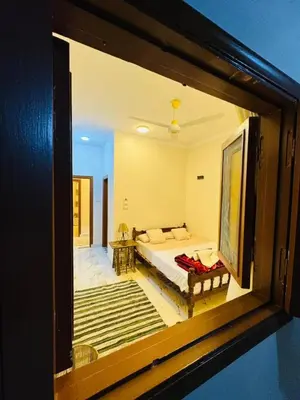 a bedroom with a bed and a view of a room at MERIT Guest House in Aswan