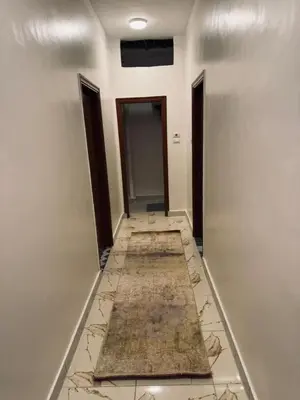 an empty hallway with a tile floor and two doors at MERIT Guest House in Aswan