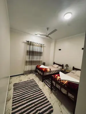 a room with two beds and a window at MERIT Guest House in Aswan