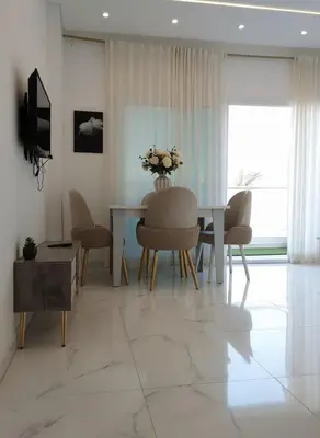 a living room with a dining room table and chairs at Hurghada luxury apartment sea view 5 in Hurghada