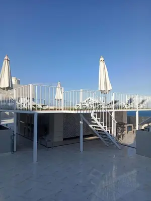 a deck with chairs and umbrellas on top of a building at Hurghada luxury apartment sea view 5 in Hurghada