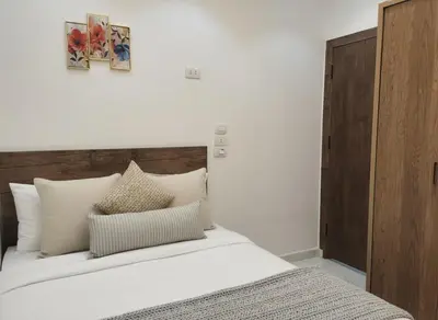 a bedroom with a bed with white sheets and pillows at Hurghada luxury apartment sea view 5 in Hurghada