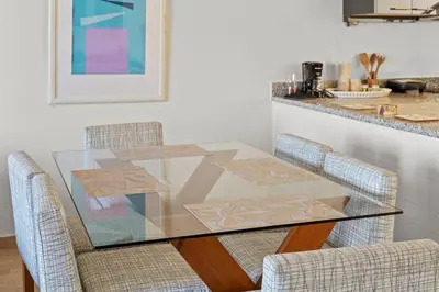a glass dining room table with two chairs at The Charming Beach Front Villa At Fanadir Bay W Private Pool in Hurghada