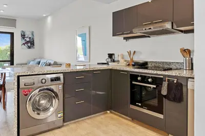 a kitchen with a washer and a washing machine at The Charming Beach Front Villa At Fanadir Bay W Private Pool in Hurghada