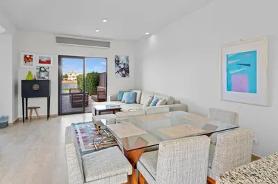 a living room with a glass table and chairs at The Charming Beach Front Villa At Fanadir Bay W Private Pool in Hurghada