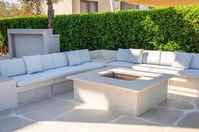 a white couch sitting on top of a patio at The Charming Beach Front Villa At Fanadir Bay W Private Pool in Hurghada