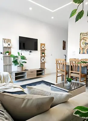 a living room with a couch and a tv at Hurghada luxury apartment sea view in Hurghada