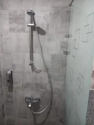 a shower with a shower head in a bathroom at شقة اللؤلؤة in Hurghada