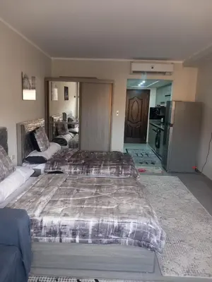 a large bedroom with two beds and a kitchen at شقة اللؤلؤة in Hurghada