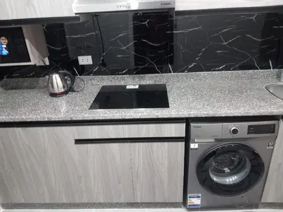 a kitchen counter with a washing machine in a kitchen at Naseem Home in Hurghada