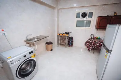 a laundry room with a washing machine and a sink at Karnak Temple Inn in Luxor