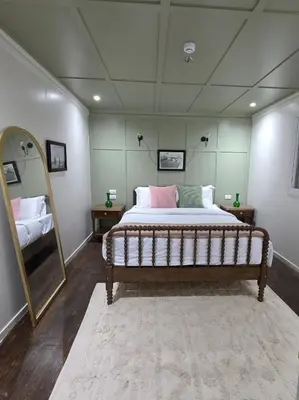 a bedroom with a large bed and a mirror at Miss Fatima Dahabiya-Nile Cruise 4 night sailing-Includes English speaking Guide and site seeing -All inclusive excluding alcoholic beverages in Luxor