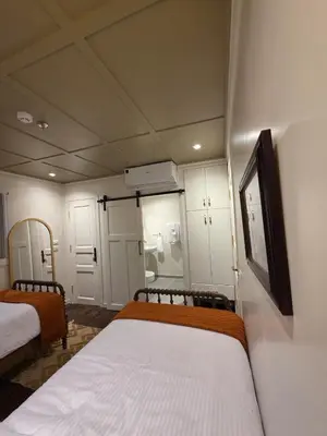 a small room with two beds and a window at Miss Fatima Dahabiya-Nile Cruise 4 night sailing-Includes English speaking Guide and site seeing -All inclusive excluding alcoholic beverages in Luxor