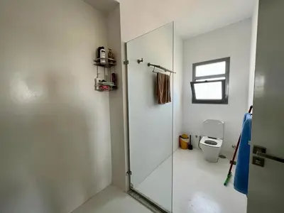 a bathroom with a shower and a toilet at 4BR Penthouse, Lagoon View, Swanlake El Gouna in Hurghada