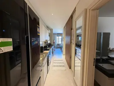 a kitchen with a long hallway with sinks and counters at Spacious Gouna Studio | Pool Access + Terrace in Hurghada