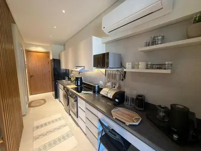 a large kitchen with a counter top in a room at Spacious Gouna Studio | Pool Access + Terrace in Hurghada