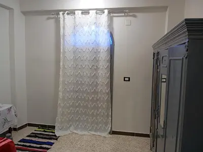 a curtain on a wall in a room at Rafe Guest House in Luxor