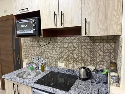 a small kitchen with a sink and a microwave at Tiba Golden Beach Hurghada in Hurghada