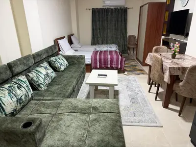 a living room with a couch and a table at Tiba Golden Beach Hurghada in Hurghada