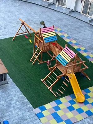 two chairs and a slide on a playground at Tiba Golden Beach Hurghada in Hurghada