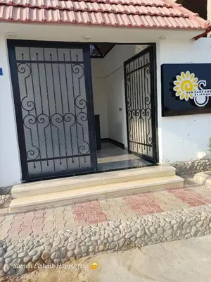 an entrance to a house with a black gate at Suncare America in Hurghada