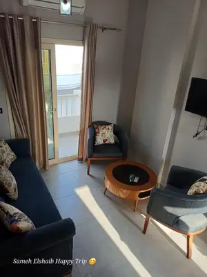 a living room with a couch and a table at Suncare America in Hurghada