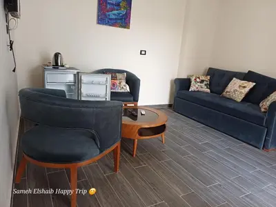 a living room with a couch and a table at Suncare America in Hurghada