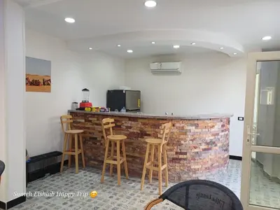 a kitchen with a brick bar with stools at Suncare America in Hurghada
