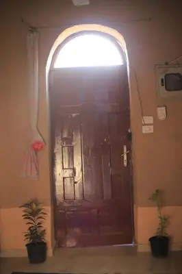 a large door in a room with a window at Moonlight in Al Aqālitah