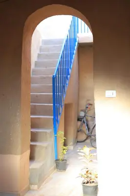 a set of stairs with a blue railing and a bike at Moonlight in Al Aqālitah