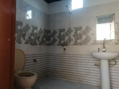 a bathroom with a toilet and a sink at Moonlight in Al Aqālitah