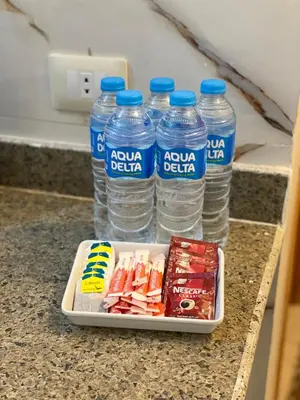 a tray of water bottles and snacks on a counter at Luxe Nest Luxor Serviced Apartments 302 in Luxor