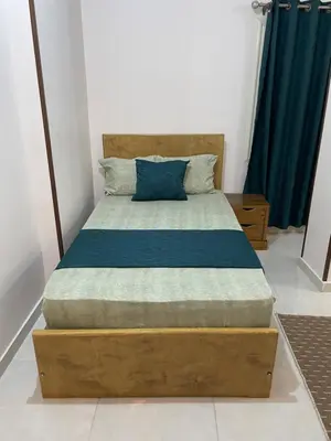 a bedroom with a bed with a blue pillow on it at Luxe Nest Luxor Serviced Apartments 302 in Luxor