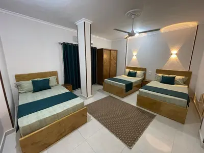 a bedroom with two beds with blue pillows at Luxe Nest Luxor Serviced Apartments 302 in Luxor