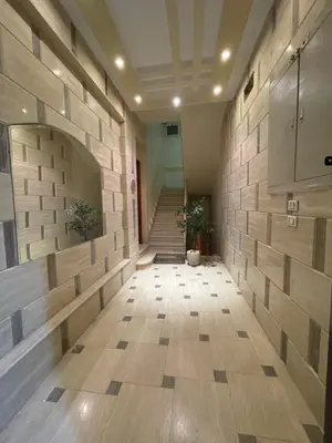 an empty hallway with a stone wall and stairs at Luxe Nest Luxor Serviced Apartments 302 in Luxor