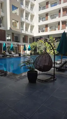 a patio with a chair and a pool in a building at 2 Bedroom Duplex - Hurghada in Hurghada