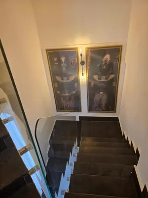 an escalator in a building with paintings on the walls at 2 Bedroom Duplex - Hurghada in Hurghada