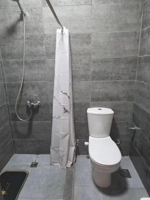 a bathroom with a toilet and a shower curtain at 2 Bedroom Duplex - Hurghada in Hurghada